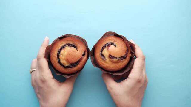 Top view of women hand holding muffin 