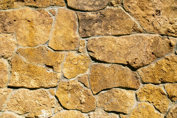 Background of stone wall texture. Yellow stone.