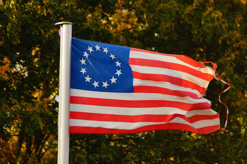 The Betsy Ross flag flies in an allotment garden.