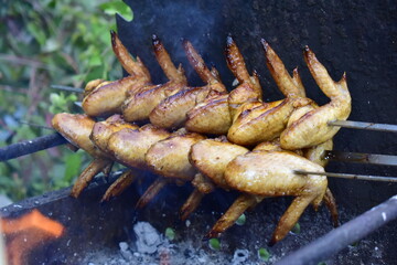 chicken wings are fried on the grill