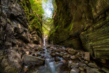 Nice waterfall and stream, deep in the canyon, at Domaine du ruisseau creux, Bonaventure, Quebec, Canada