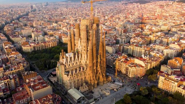 Temple Expiatori La Sagrada Familia in Barcelona, Catalonia, Spain. Flying around the architectural masterpiece of Gaudi in the sunrise, UHD, 4K
