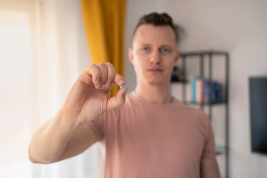 A young man takes a prep in a pill. HIV prevention concept. AIDS prevention concept.