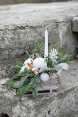 Eco christmas table decoration with candle, lobes and cones in wood sleight.