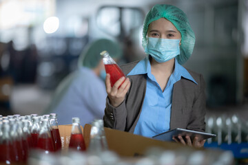 worker working in industry factory for production of bottle water fruit drink