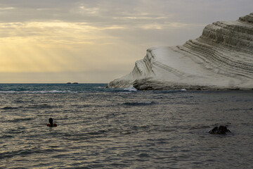 Girl having bath at the sunset in Scala dei Turchi, Realmonte, Agrigento, Sicily, Italy