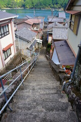 Fototapeta na wymiar Stairs and Aerial view of Fisherman's village, Traditional Japanese town of Sugari-cho, in Mie, Japan - 三重県 尾鷲市 須賀利町の街並み