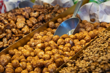 Candied almonds coated in browned, crunchy sugar, typical sweet food on a fun fair and Christmas...