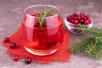 Red cocktail made from fresh cranberries on a gray background.	