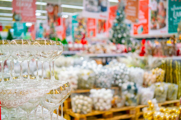 Glass goblets on a blurry Christmas background with festive goods.