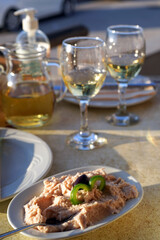 taramasalata dip and white wine on the table in greek tavern
