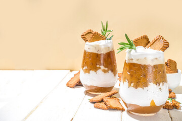 Biscoff coffee latte with cookie pasta, whole cookies, whipped cream and rosemary decor 