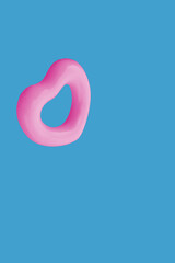 Fototapeta premium Pink Heart Tube on Blue Water