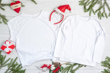 White t shirt mockup with copy space and Christmas Holiday template flatlay. Top view blank t-shirt...