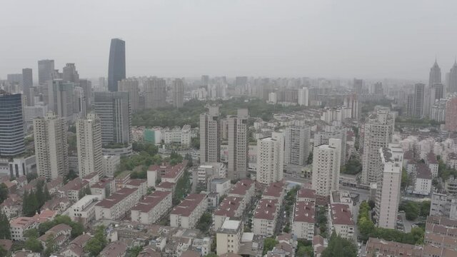 Drone flying over a residential populous neighbourhood in Shanghai, China. Big and medium sized residential buildings, image showing some vintage ceilings and other recently  constructed.