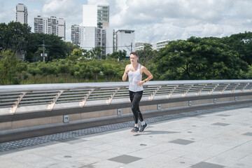 Sporty active young man in sportswear jogging in the park. Fit caucasian man running outdoors.Healthy lifestyle concept, sport outdoor, training