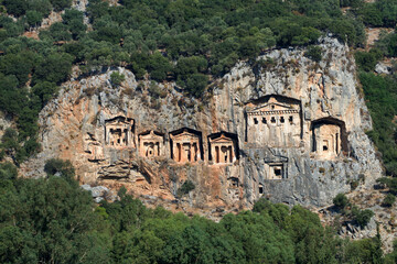 Fototapeta premium Rock-cut temple tombs in Kaunos Dalyan - Turkey (Turkish name; kaya mezarlari) Ancient city of Kaunos, Dalyan valley, Turkey. Kaunos (Latin: Caunus) was a city of ancient Caria and in Anatolia
