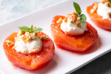Traditional Turkish style quince dessert. The quince is cooked until soft, sherbet is poured on it,...