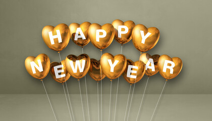 Gold happy new year heart shape balloons on a grey concrete background. Horizontal banner