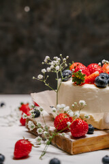 Beautiful strawberry cake decorated with blueberries on a white background
