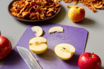 fresh apples cut on a cutting board for drying, dried fruit