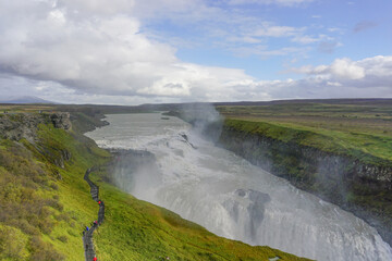 Southwest Iceland: Visitors walk along a trail as mist rises from Gullfoss (Golden Falls), the most famous waterfall in Iceland.