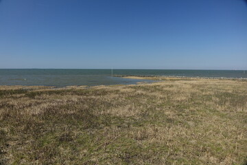 Sahlenburg beach at high tide on a sunny spring day, Sahlenburg, Cuxhaven, Lower Saxony, Germany
