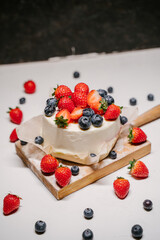 small strawberry bento cake. garnished with strawberries and blueberries