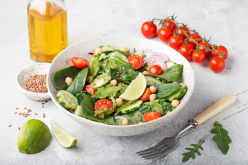 vegetarian chickpea salad with tomatoes, cucumber, red onion, arugula. vegetarian protein and fiber.