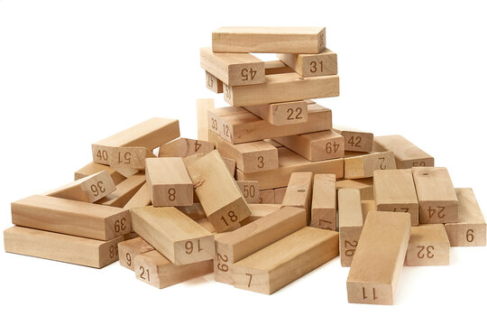 The fallen tower from the wooden blocks of the game Jenga Tower on a white background close-up. Home entertainment