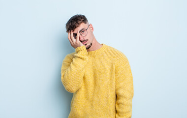 young handsome man feeling bored, frustrated and sleepy after a tiresome, dull and tedious task,...