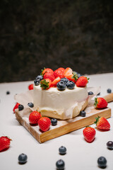 small strawberry bento cake. garnished with strawberries and blueberries