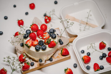 Bento cake with berries in a white package - container