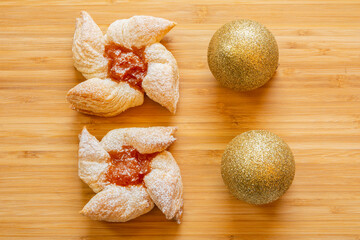 Joulutorttu, traditional finnish christmas pastry with marmalade on the wooden board and christmas...