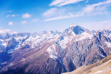 Beautiful snowy mountains against the blue sky on a clear sunny day. Beautiful landscape. Active tourism and winter sports.