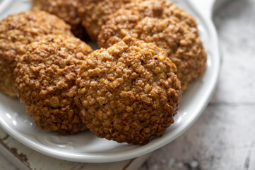 Close up homemade oat cookies, healthy snack over bright background