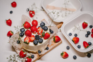 Beautiful strawberry cake decorated with blueberries on a white background