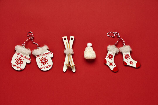 Christmas banner. Toy attributes of winter and Christmas on a red background. Concept of symbolic items.