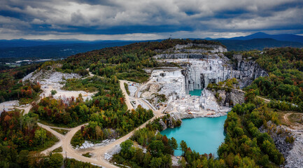 Fototapeta na wymiar Aerial of Ages - A drone shot of this beautiful granite quarry in Vermont. With stunning, turquoise water, which gets its color from the fallen granite pieces.
