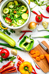 cooking vegetables on the stone background top view