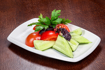 Salad with sliced vegetables - tomato and cucumber