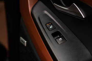 Seat heating controller buttons close up view. Car interior. Seat heater button, car interior. The...