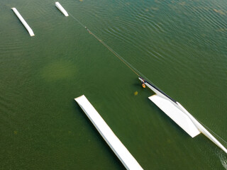  Wakeboarding surfing in wake park from above. 