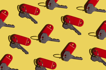 Bright yellow and red background with keys from the doors. Lots of keys: apartments for sale, hotel...