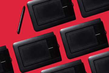 graphic tablets with pen for design on red background