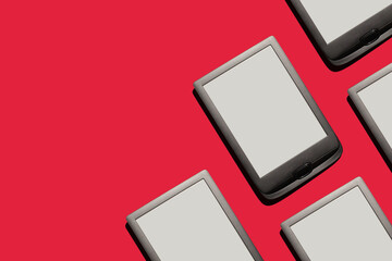 e-reader tablets screens on red background