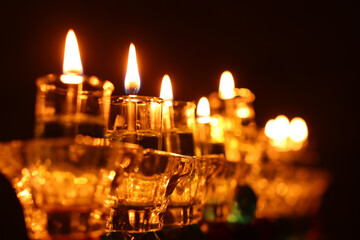 image of jewish holiday Hanukkah background with crystal menorah (traditional candelabra) and oil...