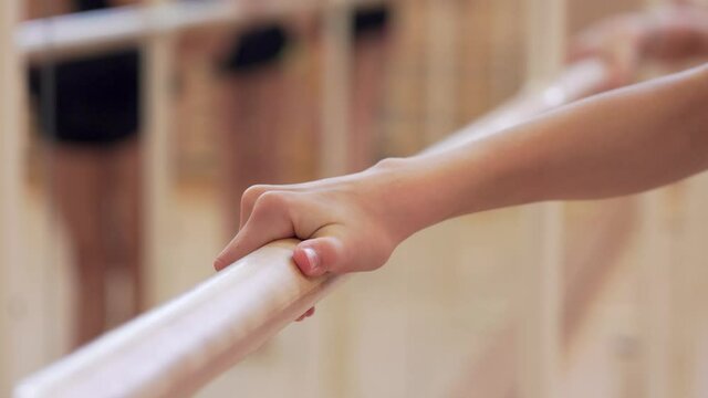 Young gymnasts perform ballet exercices during choreography training