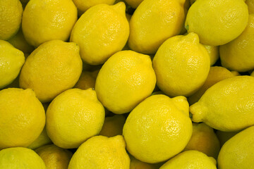 fresh organic spanish lemons on the market. harvest, background, food texture.