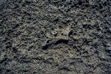 Black volcanic stone macro closeup. High quality photo